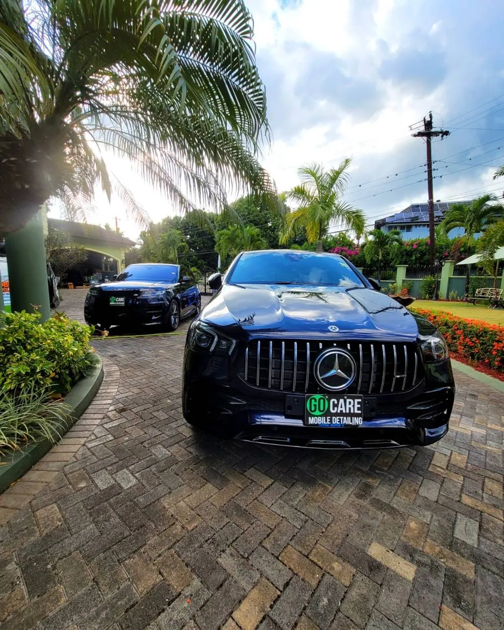 Mercedes and Range Rover with Go Care plates on a driveway