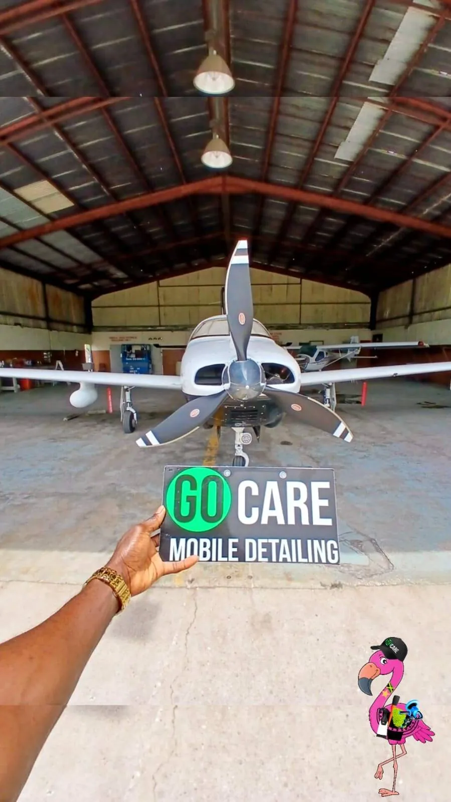 Go Care sign held in front of an aircraft in a hangar