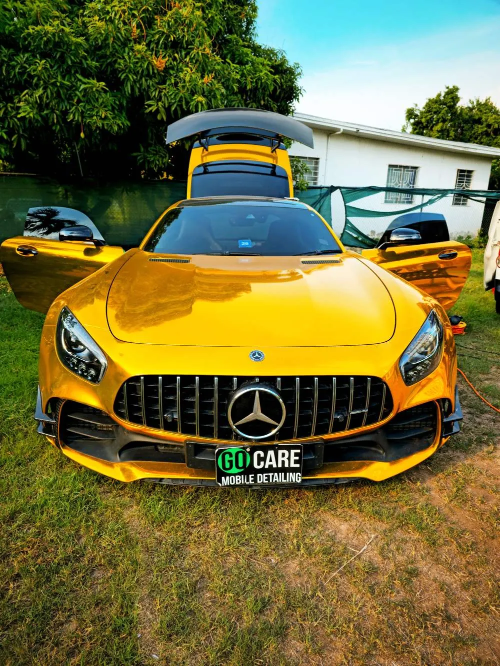 Gold Mercedes AMG GT with doors open