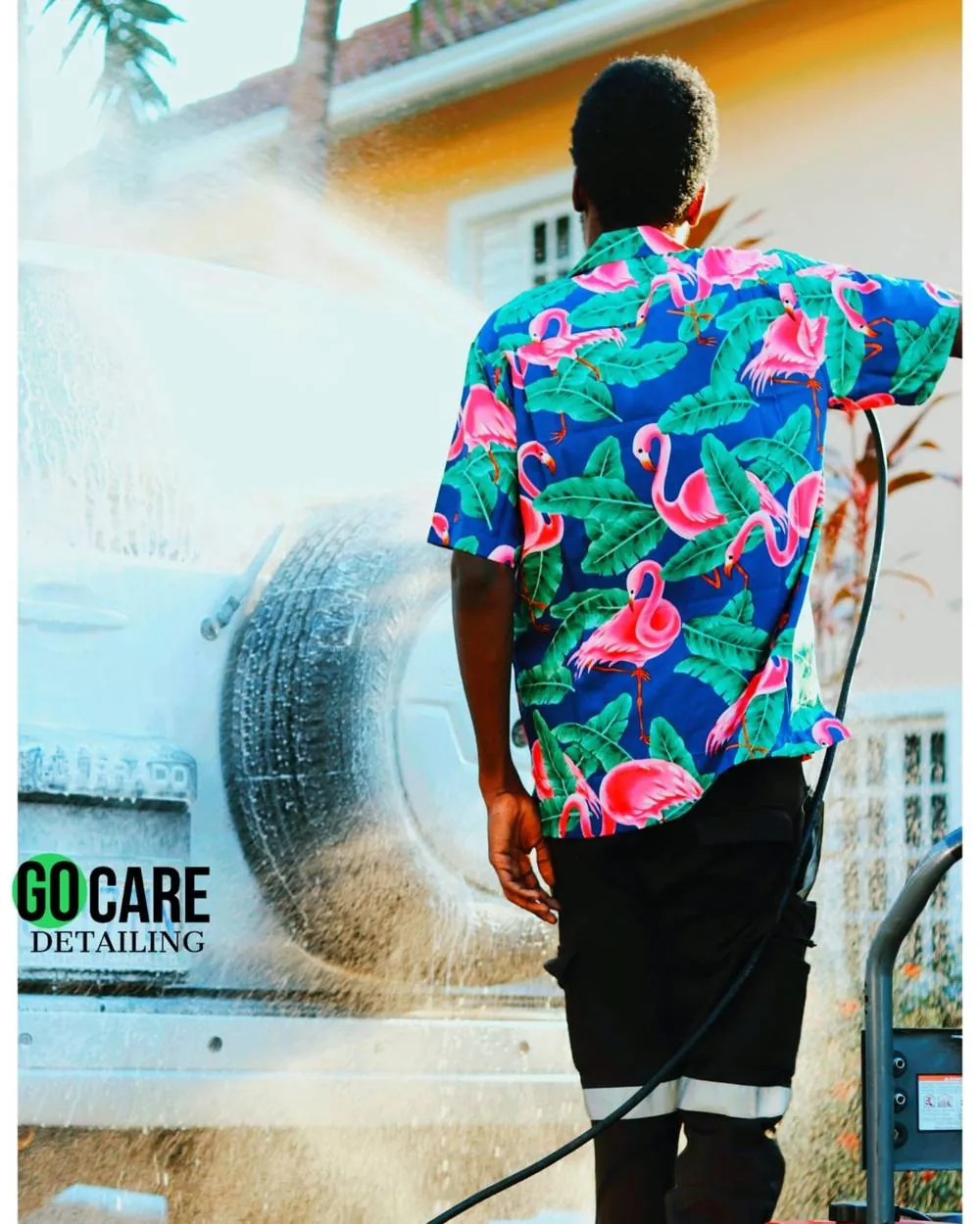 Go Care technician pressure washing a vehicle