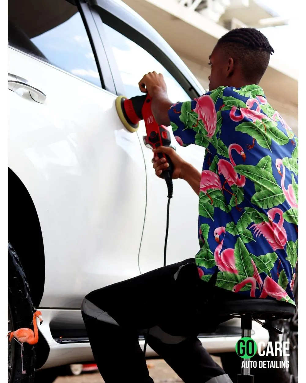 Go Care technician machine polishing a white vehicle