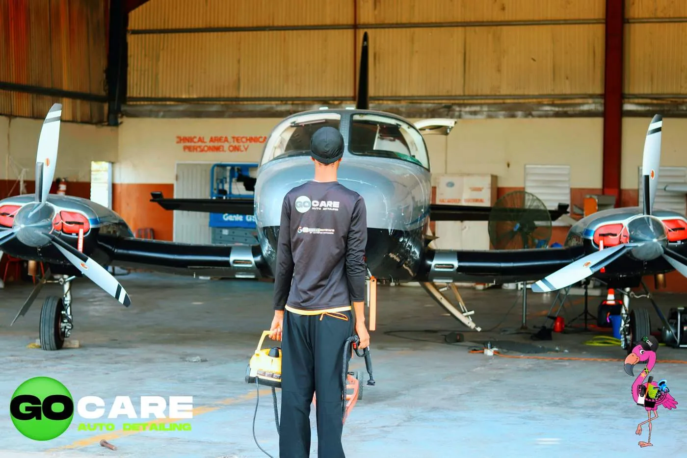GO CARE technician steam cleaning an aircraft in a hangar