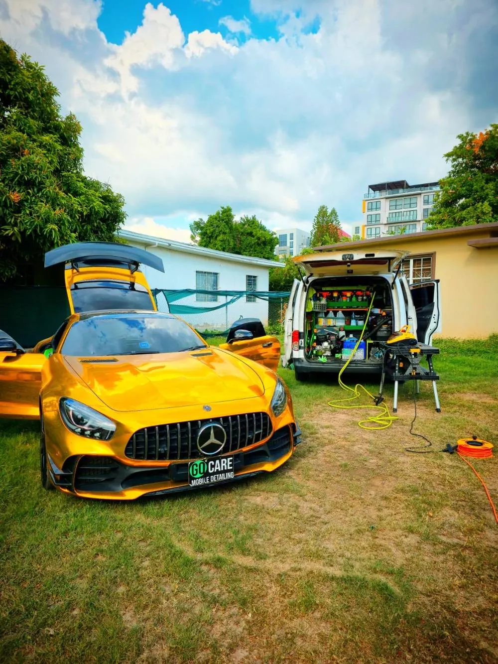 Gold Mercedes-AMG GT beside the GO CARE mobile detailing van, ready for ceramic coating and detailing