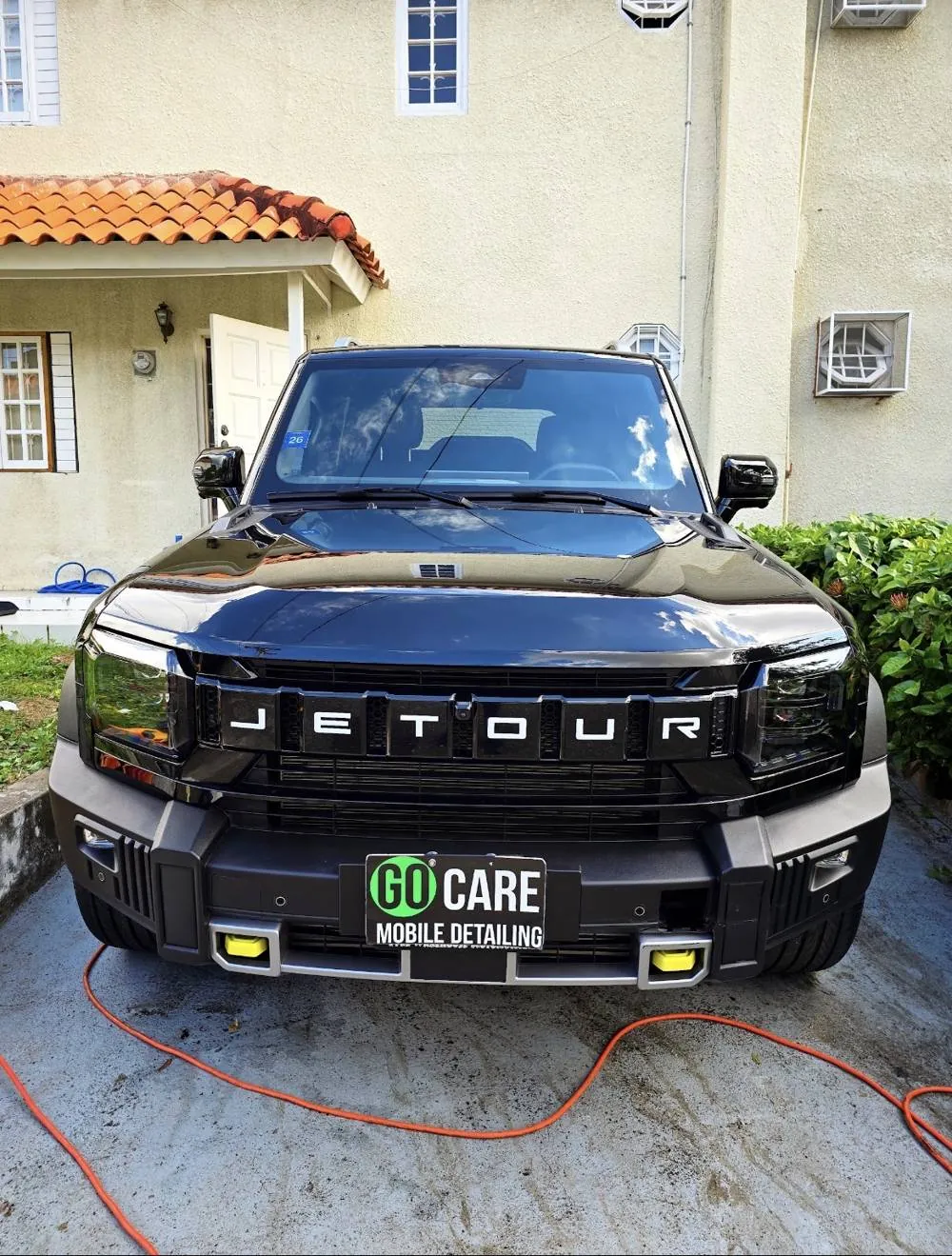 Black Jetour SUV with a Go Care plate after a full interior and exterior detail